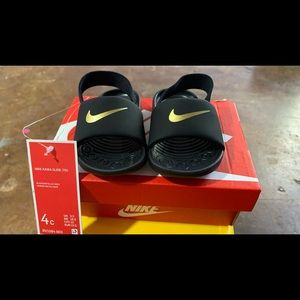 I am selling baby slippers,brandNike,size4c, Color black and goldNike kawa slide
